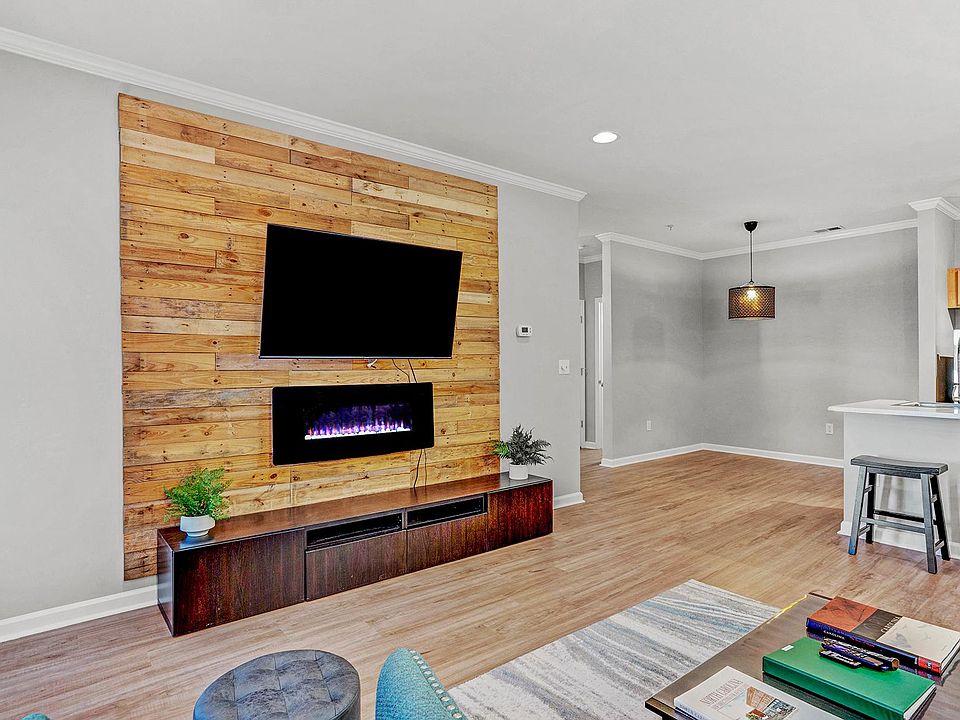 Beautiful wood feature wall complete with electric fireplace and wall mounted tv.
