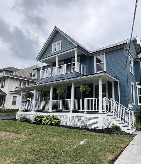 porch has separate staircases & sidewalks.