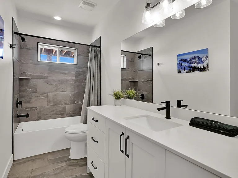 Shared hallway bathroom with tub and shower