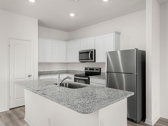 The chef-ready kitchen features granite countertops and stainless steel appliances.