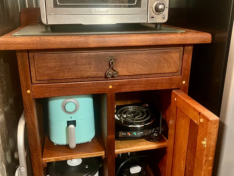 Toaster oven, air frier, electric stove-top burner, rice maker, and two-slice toaster.