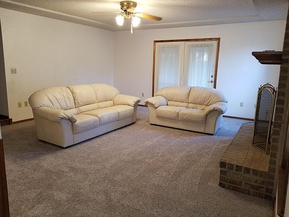 Large living rm with brick fireplace, gas jet and wood burni