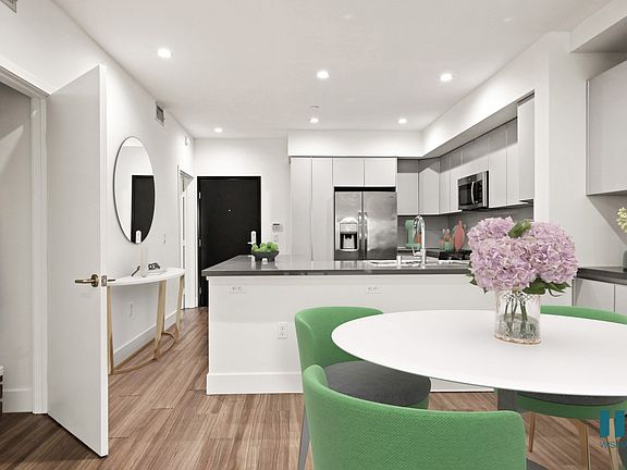 Open-Concept Kitchen and Dining Room with Hall Closet and Built-In Storage Cabinets