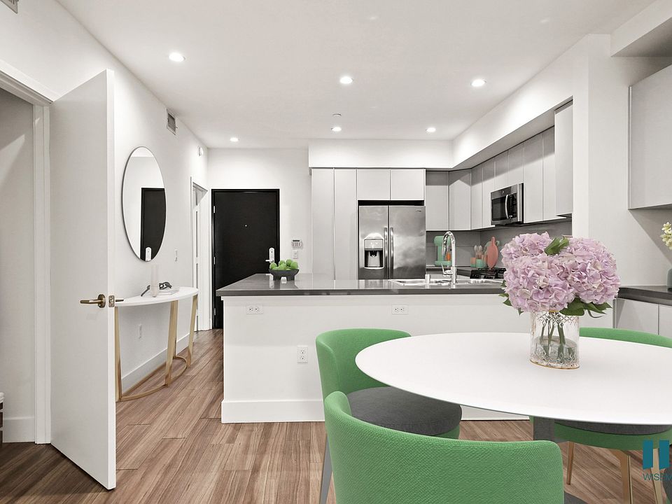 Open-Concept Kitchen and Dining Room with Hall Closet and Built-In Storage Cabinets