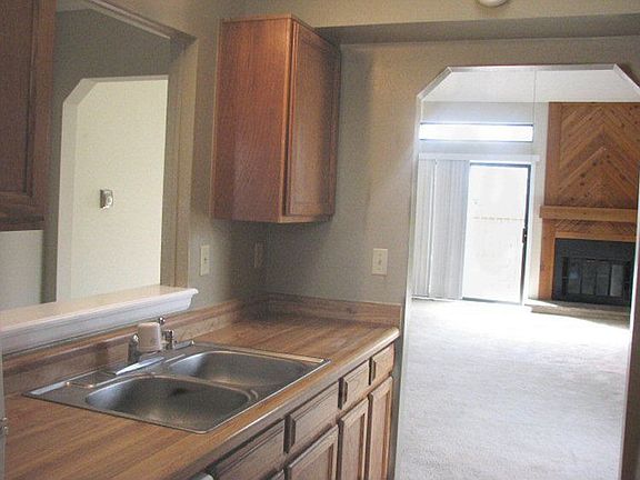 Galley-style kitchen opens into main dining/living room