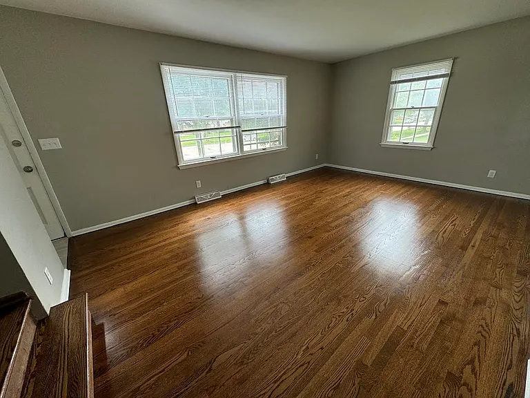 Spacious Sunny Living Room with Hardwood Floors