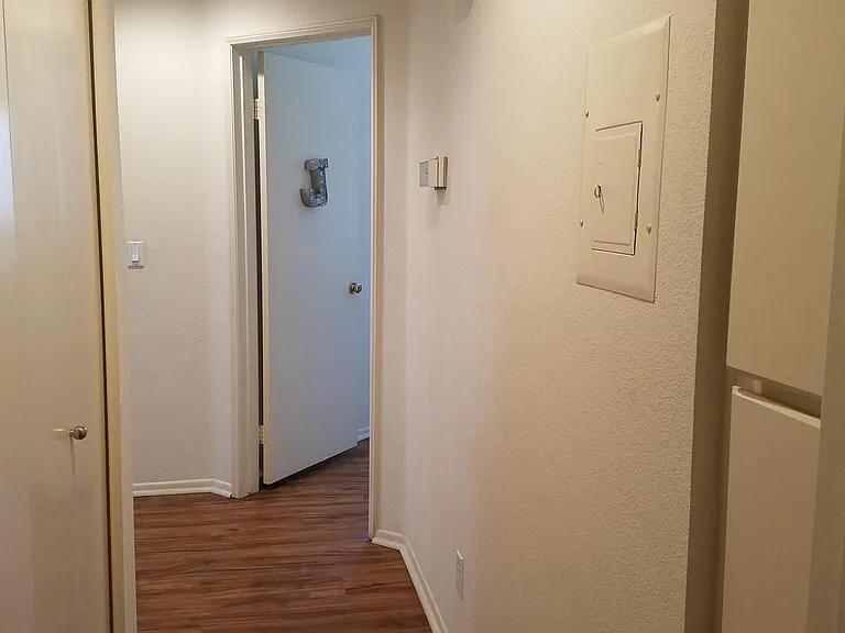 Hallway with laundry and storage cupboards