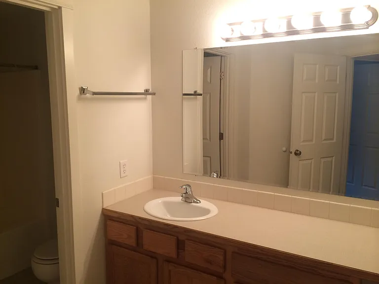 bath has vanity area seperate from bath and toilet area.