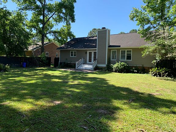 View of the rear of the house. The kitchen is on the left the Master bedroom on the right side and the Living/Dining space is in the middle.