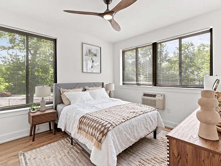 Experience comfort and style in this beautifully lit bedroom, perfect for relaxation.