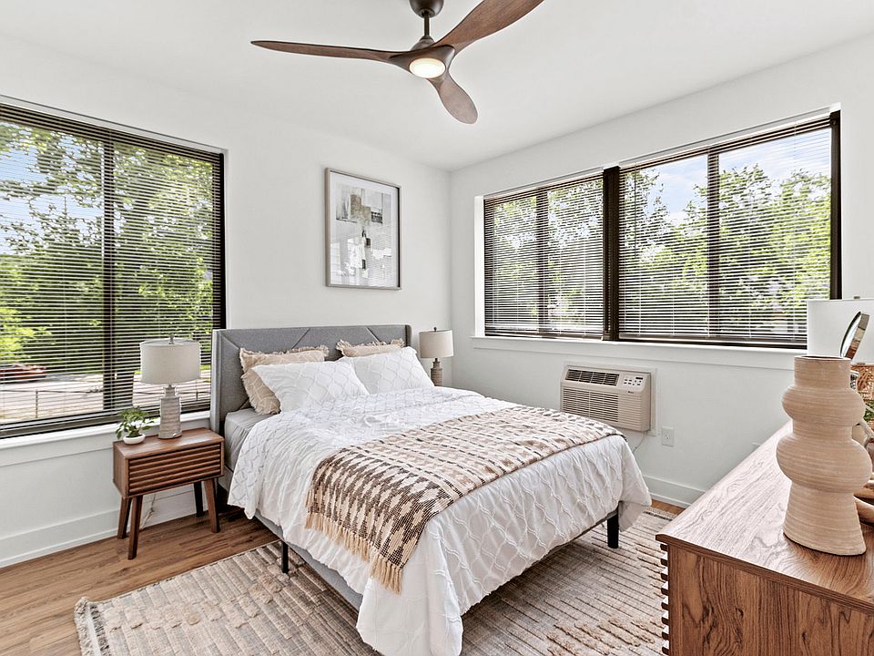 Experience comfort and style in this beautifully lit bedroom, perfect for relaxation.