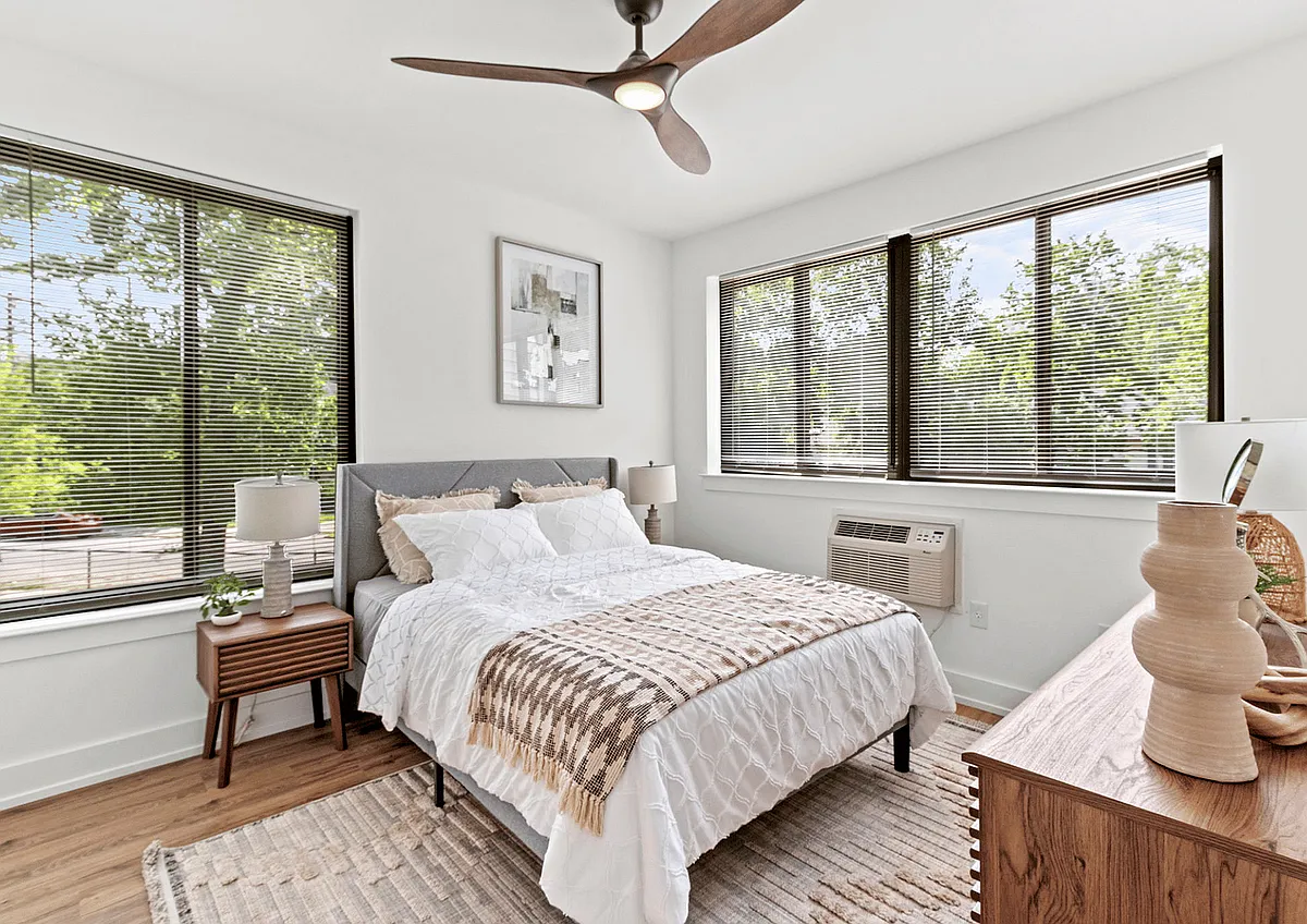 Experience comfort and style in this beautifully lit bedroom, perfect for relaxation. - Upsal Hall