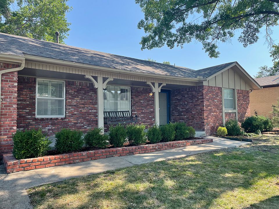Oversized covered front porch with a cute porch swing for relaxing