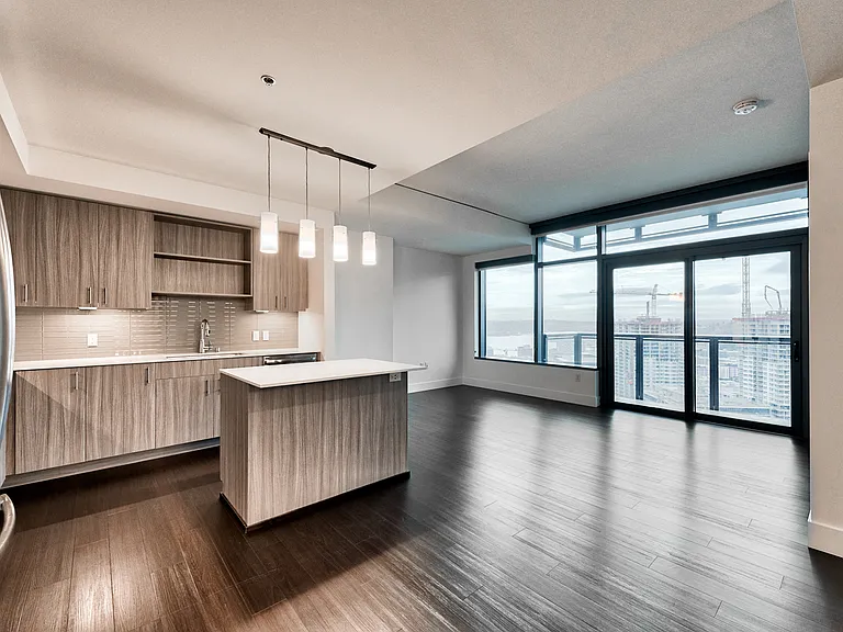 Wood plank flooring throughout the open layouts create a flexible living space