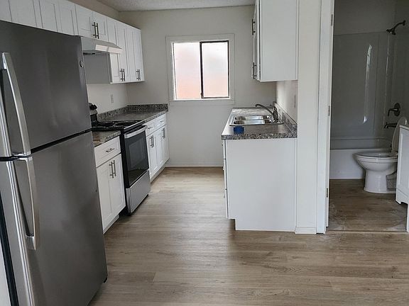 View of kitchen from 2nd door and dining area. Peekaboo of bathroom.