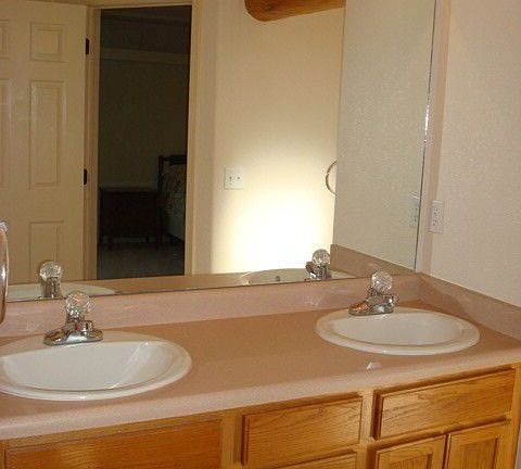 Master Bath Has Dual Sinks, Toilet Closet and Tile Floor.