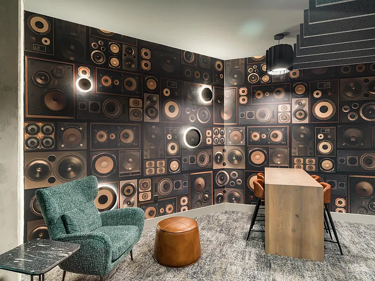 A tucked-away focus nook with sound-dampening details, comfortable seating, and a creative backdrop designed for quiet work or one-on-one conversations.