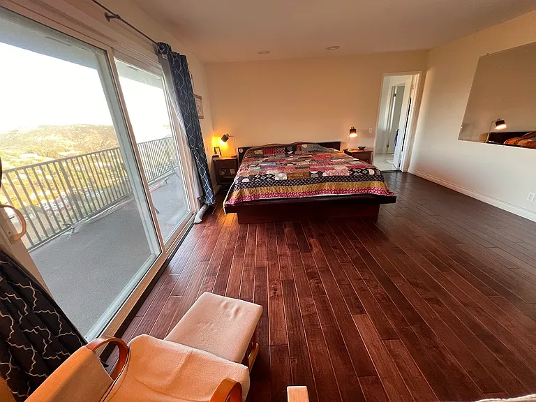 primary bedroom suite with attached balcony and views of the canyon