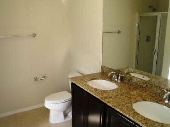Owner's bath complete with granite countertops and Moen faucets.