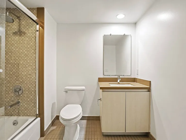 Bathroom with Shower Bath with Glass Door, and Vanity Cabinet Storage