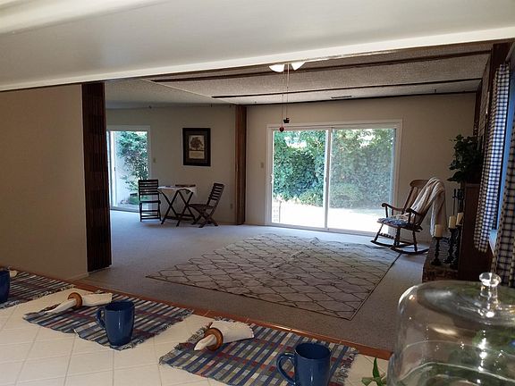 Looking into dining area and family room from the kitchen. Note the additional ar seating in the kitchen.