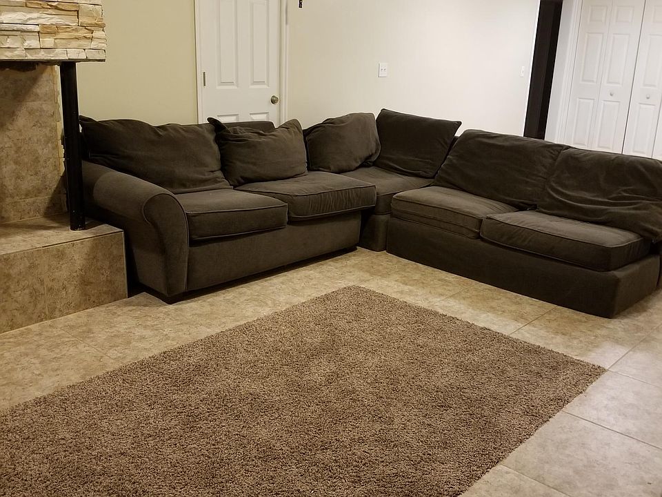 Very large front room and kitchen. The door behind the sofa has been taken out so that it is just a wall.