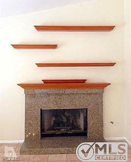 Fireplace in Family Room! Shelves for all your pictures and collectibles already provided.