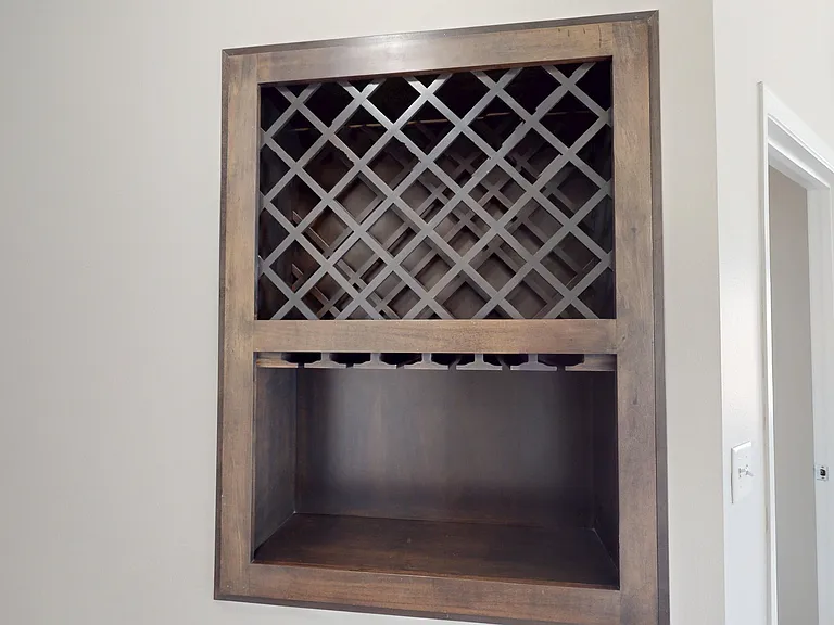 The Retreat includes a built-in wine rack and wine glass holder, providing a unique storage feature for apartment living. The Retreat includes a built-in wine rack and wine glass holder, providing a unique storage feature for apartment living.