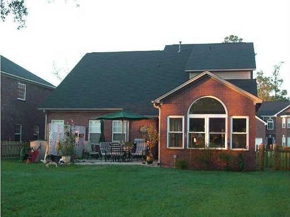 Sunrise on the back yard featuring the brick sunroom and extended patio.