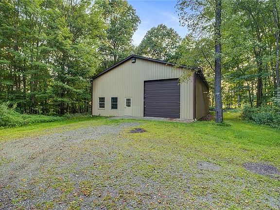 This outbuilding has a high clearance door that affords access to even the higher RV's and Boats. You will love having space for