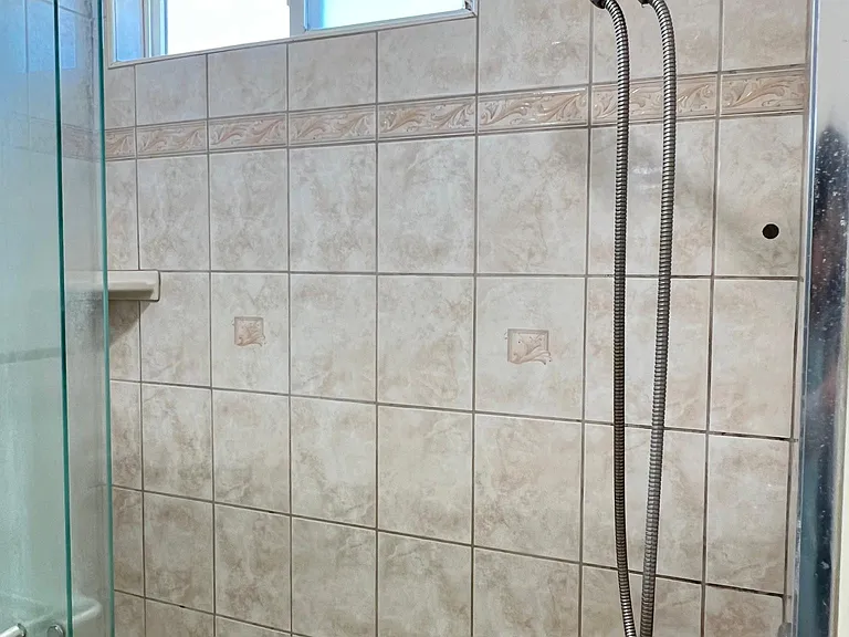 Tiled shower with sliding glass door