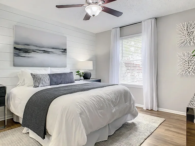 Revel in the allure of lavish primary bedroom spaces adorned with large windows and elegant flooring, a tranquil retreat for serene slumber.