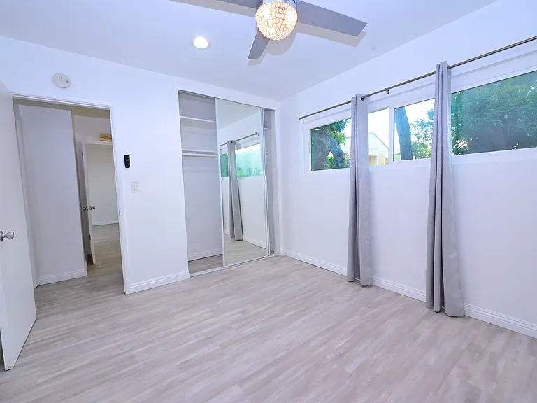 spacious master bedroom with A/C and ceiling fans