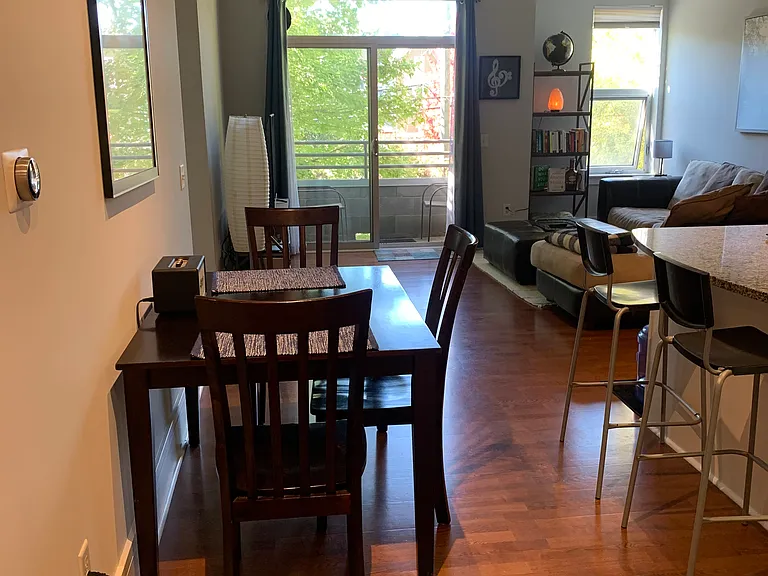 From the front hallway looking into dining area, kitchen (on the right) and living area