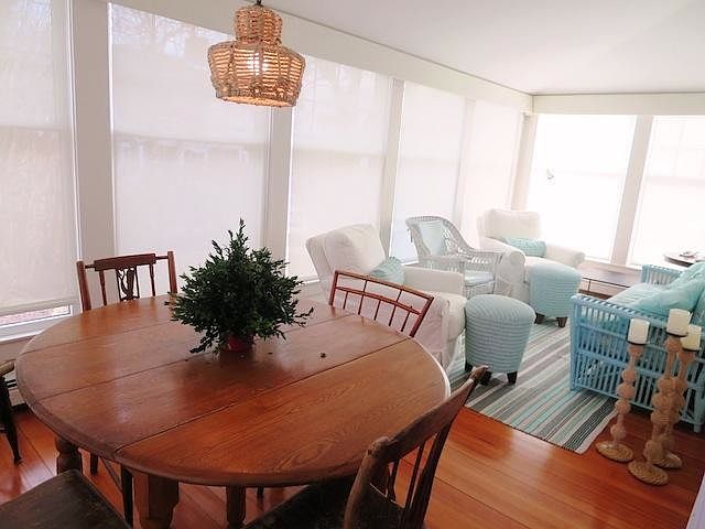Enclosed sunroom with seating and dining