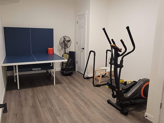 Shared exercise room, equipped with a ping pong table, elliptical, free weights, and more.