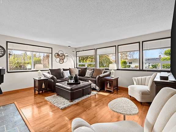 Spacious living room with an abundance of windows allowing the natural light to pour in.
