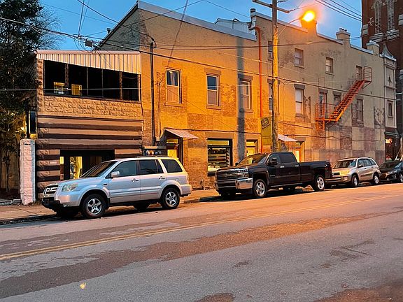 The dark window area at rear of building, second floor, shows the enclosed porch that is still being enclosed.
