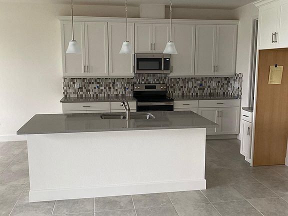 Wide open kitchen area with high ceilings
