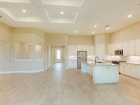 Gathering room ideally located off of kitchen with a decorative coffered ceiling