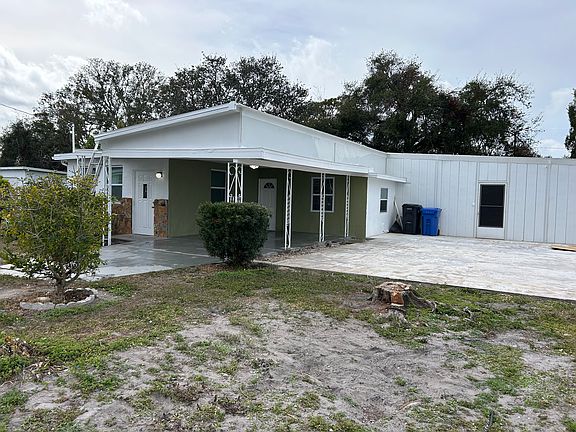 Large concrete patio on side of house