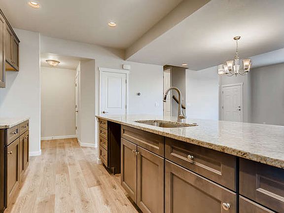 Stainless steel appliances (refrigerator, DW, oven, microwave) are included but not pictured.