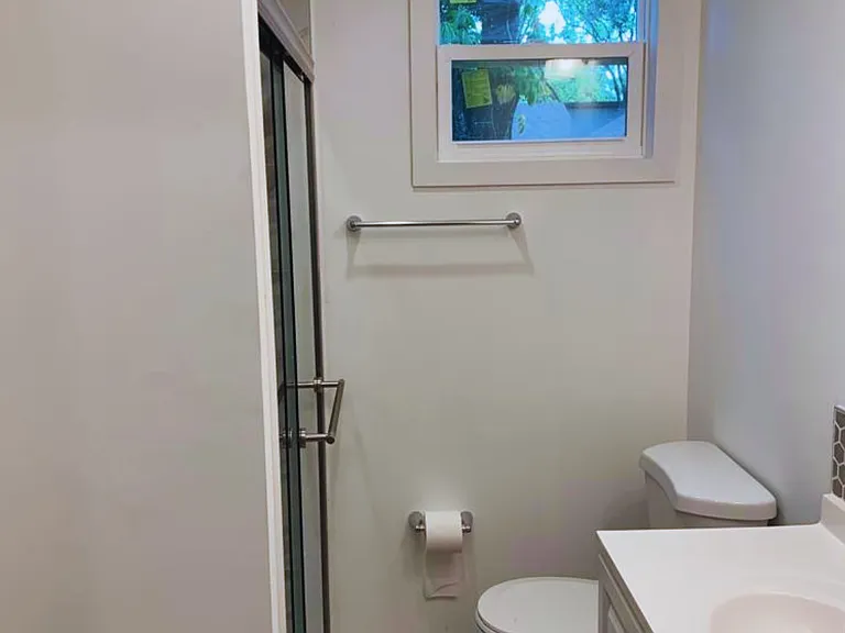 Spotless bathroom in excellent condition featuring a sink, toilet, and storage drawer for essentials. Lakeland, FL
