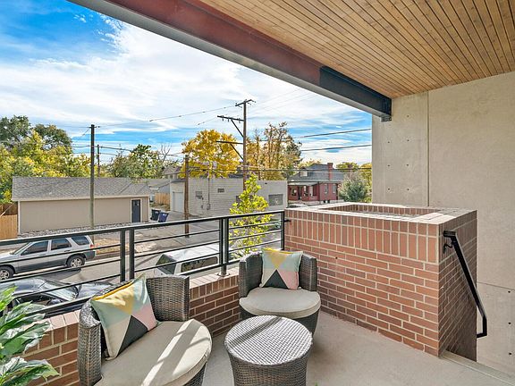 Raised porches have metal railings & exterior planters.