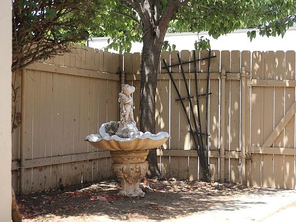 Back yard. Statue is no longer there. Plenty of space for seating or creating a garden.