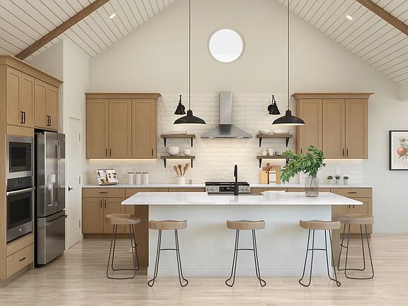 Kitchen with vaulted ceiling and stained ceiling beams