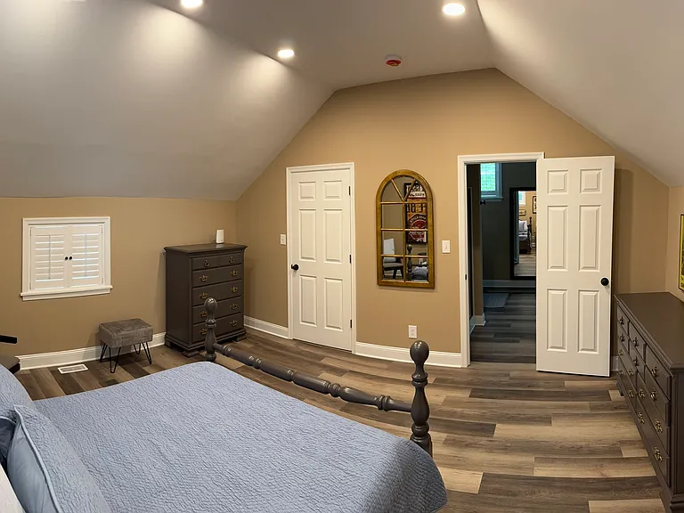 Second Floor Bedroom from a different angle. The door to the steps is closed and the bathroom door is open.