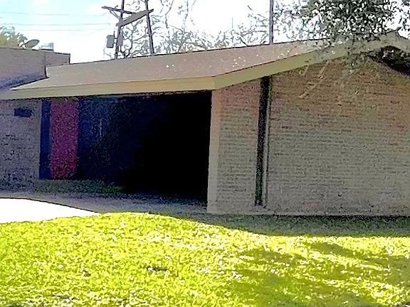 Attached brick carport for two vehicles