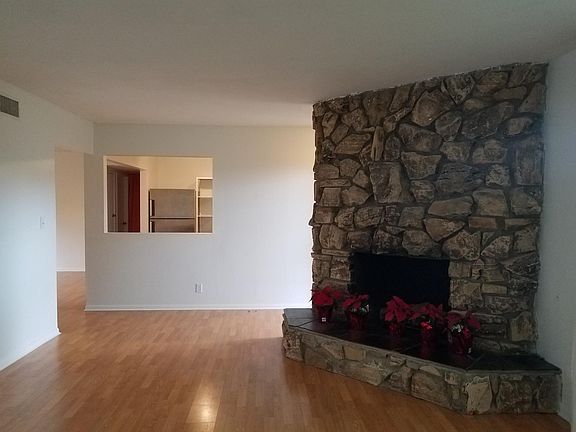 Living Room with Fireplace and window into Kitchen
