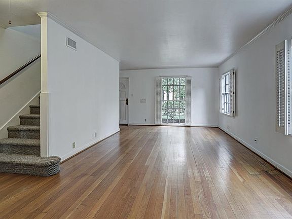 Living Room (22'x13') has oak hardwood floors, neutral tone walls, white ceiling & trim. divided-lite windows on the east and north sides to bring in good light. View is looking North towards front of the house.